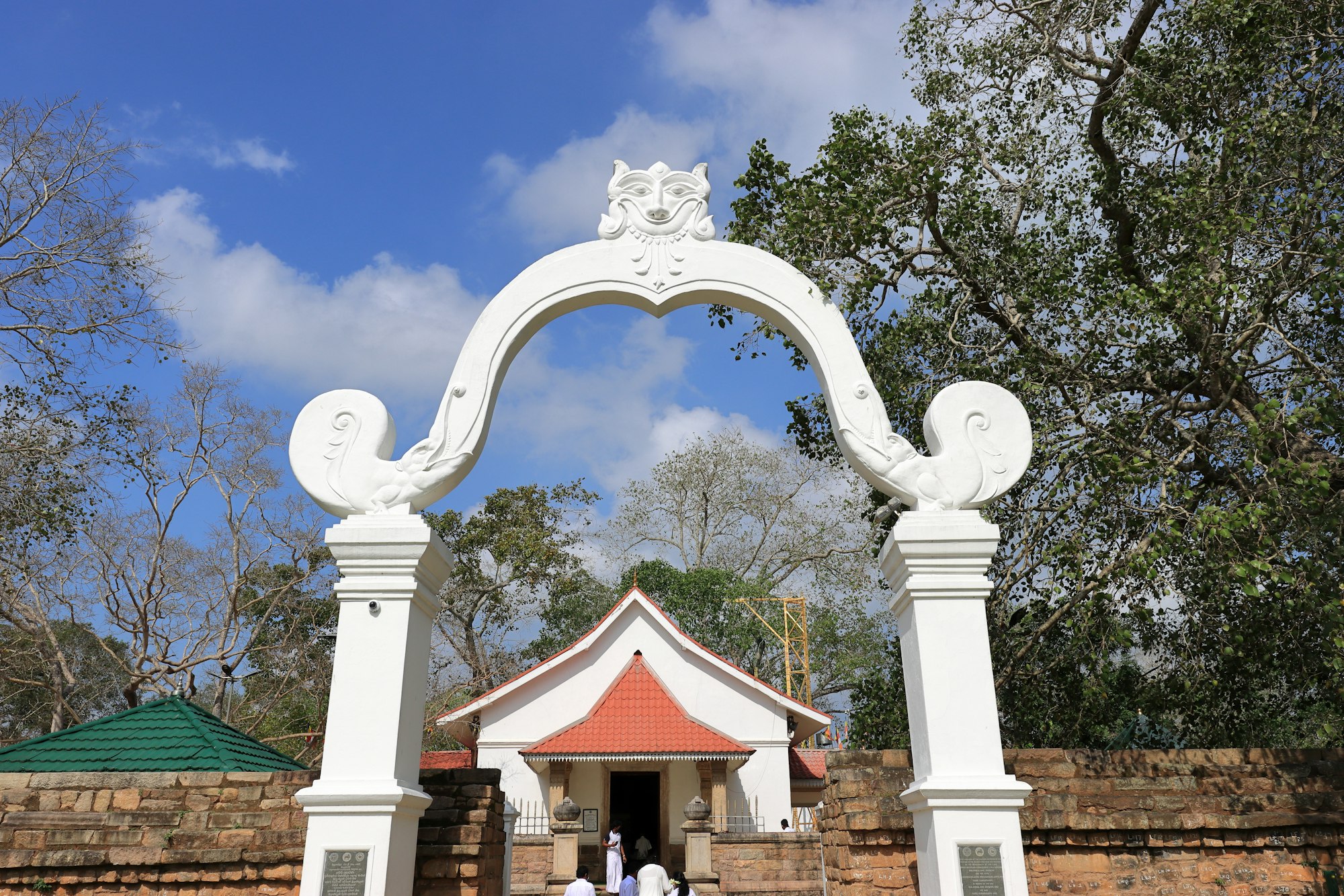 A white shrine gateway at a sacred site in Anuradhapura