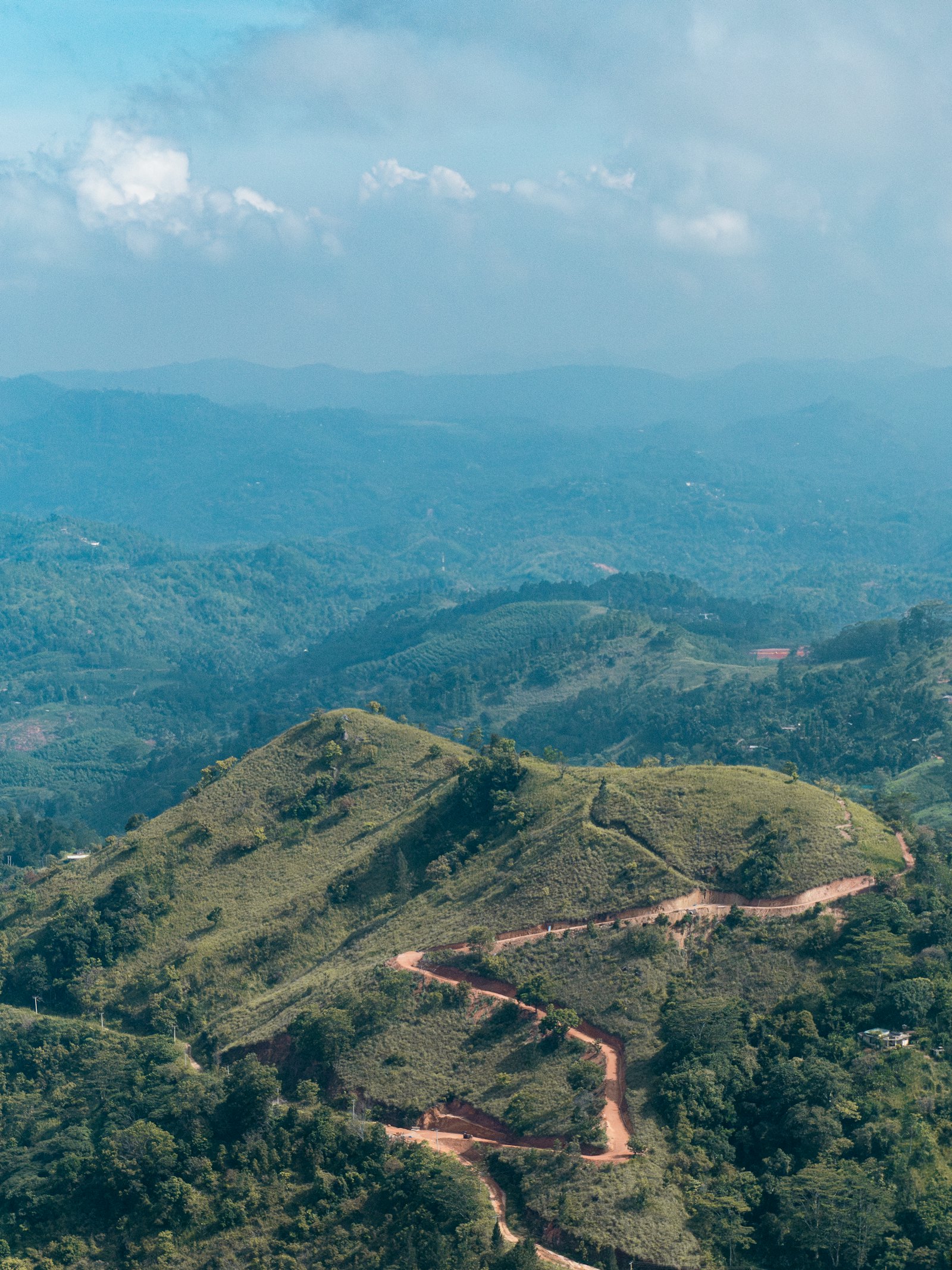 A road winding through green hills in Sri Lanka's interior